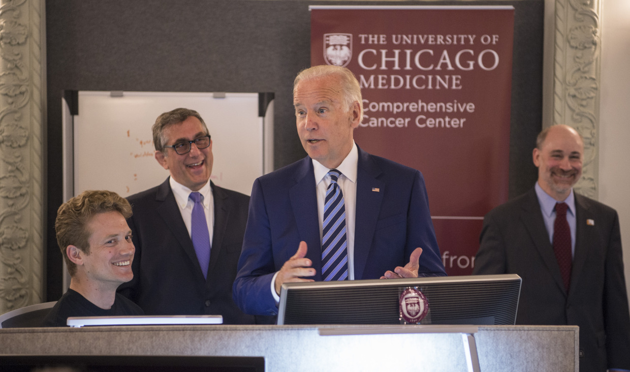 Vice President Joe Biden talks with (from left): Jeremiah Savage, MS, Ken Onel, MD, PhD, and Prof. Robert Grossman, PhD, as the vice president toured the NCI Genomic Data Commons (GDC) Monday, June 6, 2016. (Photo by Robert Kozloff; source: Genomic Data Commons at UChicago heralds new era of data sharing for cancer research)